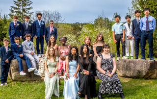 The graduating group of 19 students come together for their class photo at graduation.